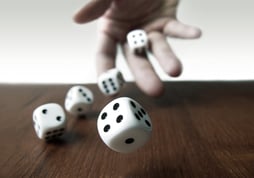 Hand Rolls dice across wood table