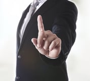 Man in Suit Holding up Pointer Finger at Camera