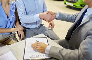 couple buying car in cublicle