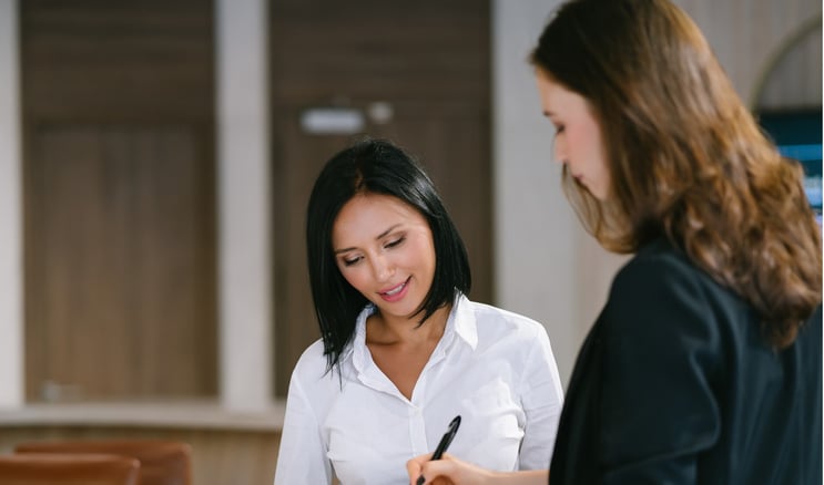 A person writing a check for a high dollar purchase