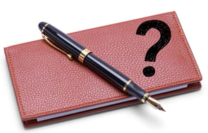 Checkbook and pen with a question mark