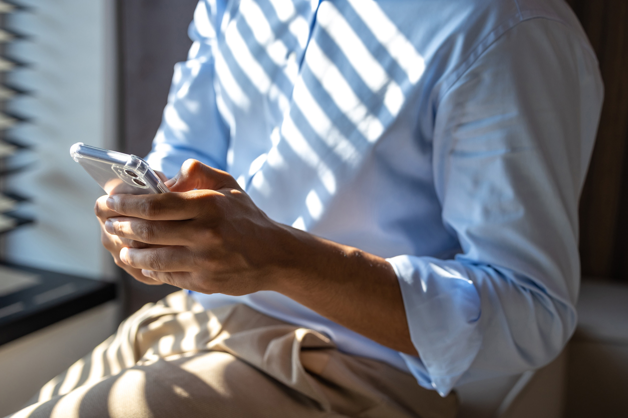 A customer using his mobile phone to make a payment provided by CrossCheck