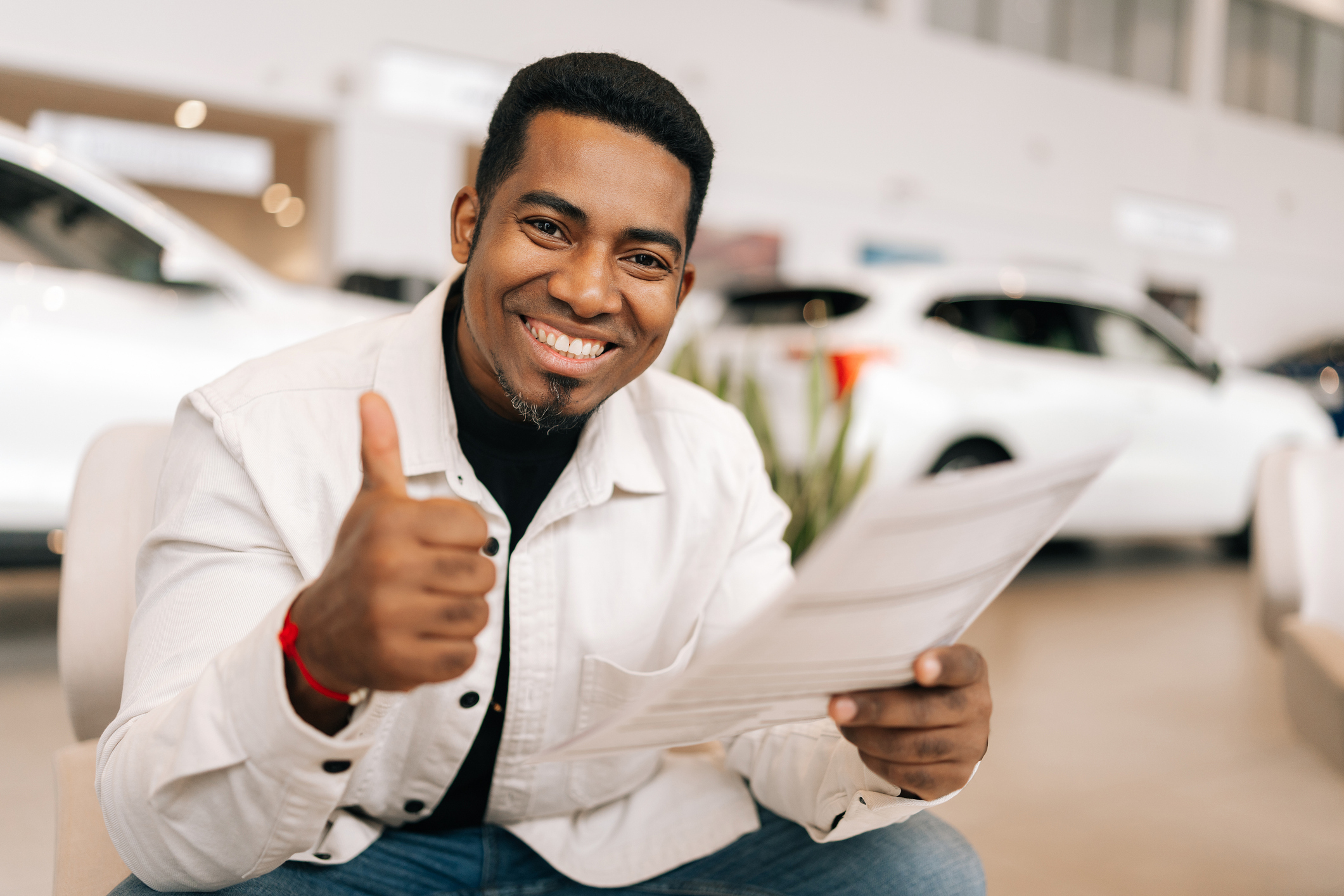 A happy person accepted to purchase a car thanks to CrossChecks Multiple Check payment solution